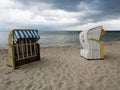 Two roofed wicker beach chairs on the Baltic coast in Travemunde, Germany Royalty Free Stock Photo