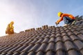 Two Roofer working on roof structure of building on construction site,Roofer using air or pneumatic nail gun and installing Royalty Free Stock Photo