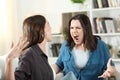 Two roommates arguing and shouting at home Royalty Free Stock Photo