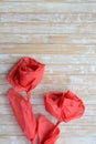 Red paper napkin roses on bamboo table background Royalty Free Stock Photo