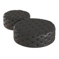 Two round quilted black leather poufs on an isolated background. 3d rendering