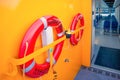 Two round red life buoys hang on the deck of a ship Copenhagen Harbour Bus