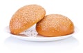 Two round sandwich bun with sesame seeds on a plate isolated Royalty Free Stock Photo