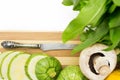 Two round zucchini cut in slices and wicker basket with vegetables Royalty Free Stock Photo