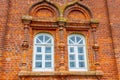 Two rounded windows on old red brick wall Royalty Free Stock Photo