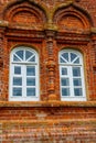 Two rounded windows on old red brick wall Royalty Free Stock Photo