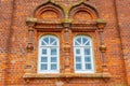 Two rounded windows on old red brick wall Royalty Free Stock Photo