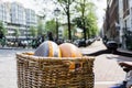 Two rounds of gouda cheese in bicycle basket