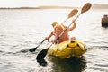 Two rowers father and son on inflatable kayak rowing by the evening sunset rays Adriatic sea harbor in Croatia near Sibenik city. Royalty Free Stock Photo