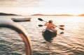 Two rowers on inflatable kayak rowing by the evening sunset rays Adriatic sea harbor in Croatia near Sibenik city. Vacation, Royalty Free Stock Photo