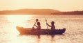 Two rowers on inflatable kayak rowing by the evening sunset rays Adriatic sea harbor in Croatia near Sibenik city. Vacation, Royalty Free Stock Photo
