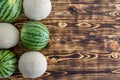 Two rows of alternating ripe melons on wood