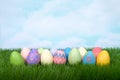 Two rows of colorful easter eggs on green grass Royalty Free Stock Photo