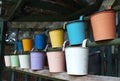 Two rows of coloured tin pots