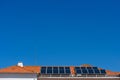 Two rows of modern clean solar panels on red tiles house roof Royalty Free Stock Photo