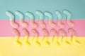 Two rows of multicolored sugar coated gummy worms on a vivid background
