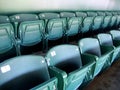 Two Rows of numbered green seats in stadium