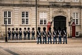 Two rows of palace guards face to face performing the change of guards at the city palace in Copenhagen. Copenhagen, Denmark - 17