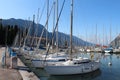 Two rows of sailboats, dock at Lake Riva, Italy