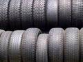 Two rows of used tires in diffused light