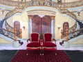 Two royal chairs under staircase background