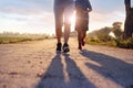 Two runner woman is running and jogging an outdoor workout on the rural road on sunset background Royalty Free Stock Photo