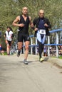 Two runners crossing the bridge