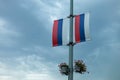 Two russian flags waving against cloudy sky in urban setting Royalty Free Stock Photo