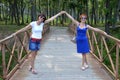 Two Russian sisters holding hands and sincerely laughing with natural laugh on a summer day