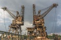 Two rusty, derelict cranes