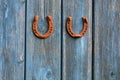 Two rusty luck symbol horseshoe on old wooden farm wall Royalty Free Stock Photo