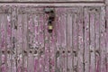 Rusty padlock locking a wooden door