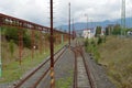 Two rusty railroad tracks in an old abandoned industrial zone in a provincial town in Eastern Europe Royalty Free Stock Photo