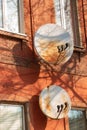 Two rusty satellite dishes on the wall of a red brick building Royalty Free Stock Photo