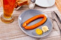 Two sacher sausages served as beer snack with horseradish and mustard
