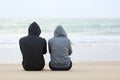 Two sad teenagers sitting on the beach Royalty Free Stock Photo