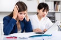 Two sad women looking documents at table in the office Royalty Free Stock Photo