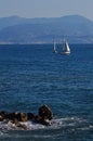 Two of sailing boats floating on the sea against the background Royalty Free Stock Photo