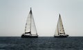 Two sailing ships crossing in the ocean against white sky Royalty Free Stock Photo