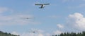 Two sailplanes beeing towed from a motorplane