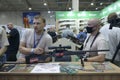 Two sales managers waiting for buyers at the counter of the gun shop, guns placed on the counter