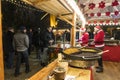 Two saleswomen in a Christmas kiosk with selling hot food. Christmas market in Poznan. Poland Royalty Free Stock Photo