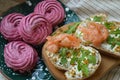 Two salmon sandwiches and purple marshmallows for breakfast. Royalty Free Stock Photo