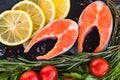 salmon steakes with greenery, lemon and cherry tomatoes