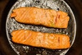 Two salmon steaks frying on the pan