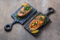 Two salmon steaks with vegetables on wooden boards, copy space Royalty Free Stock Photo