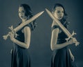 Two same attractive young pure princess girl with a sword Royalty Free Stock Photo