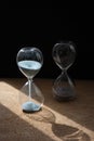 Two sandglasses on the black background Royalty Free Stock Photo