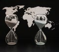 Two sandglasses, world political map, time passing