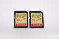 Two SanDisk Extreme 32GB UHS SD /SDHC Cards on a white desk Royalty Free Stock Photo